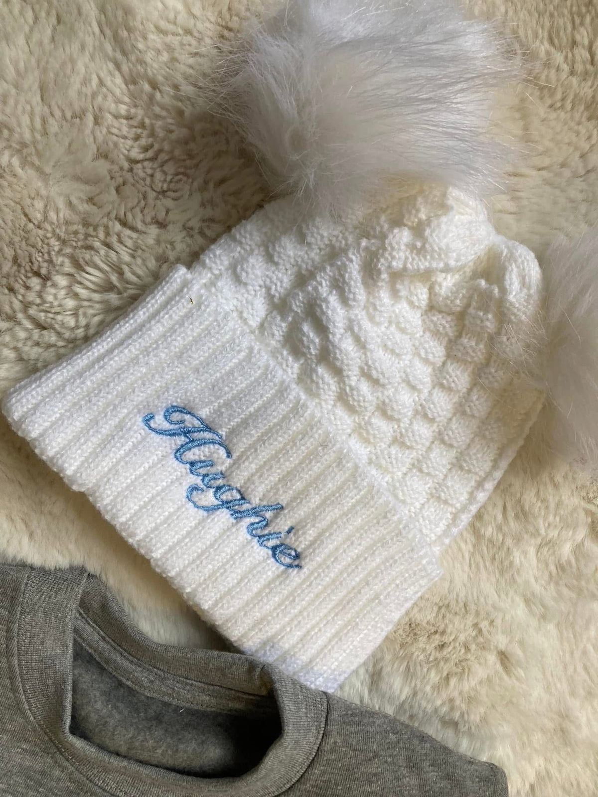 White pom pom hat
